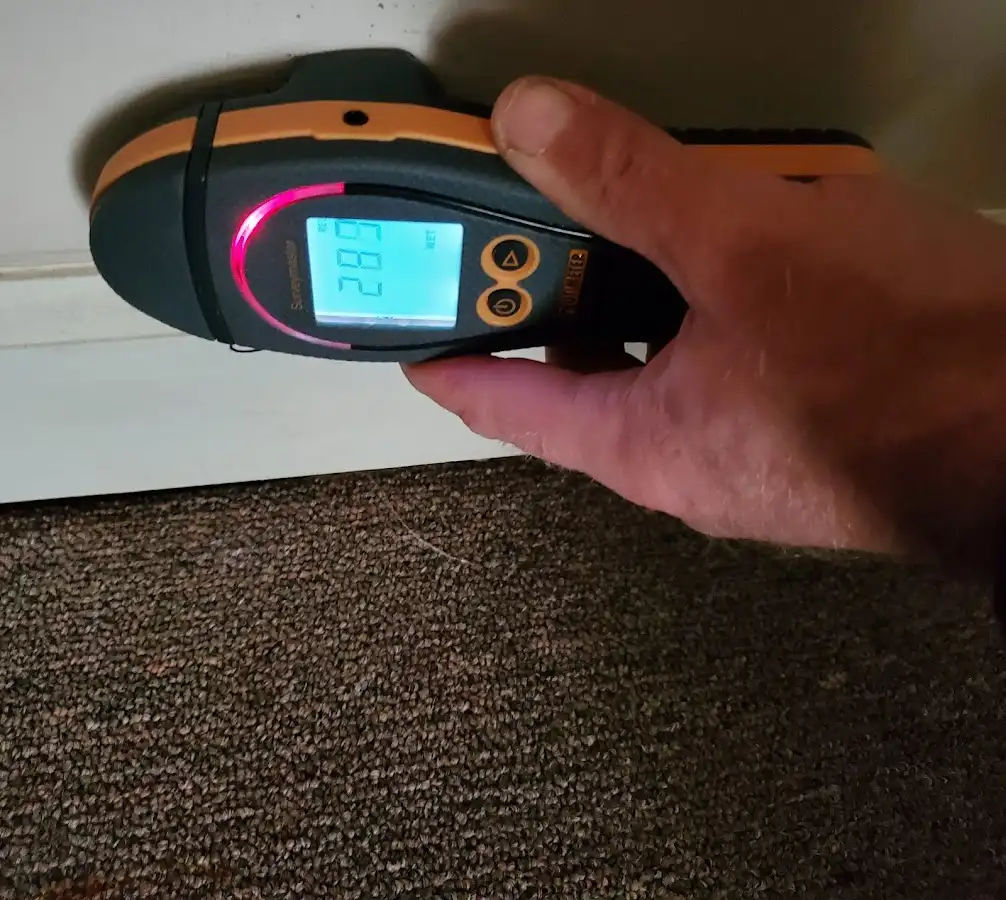 Moisture detection at baseboard during Storm Damage Restoration in Daytona Beach